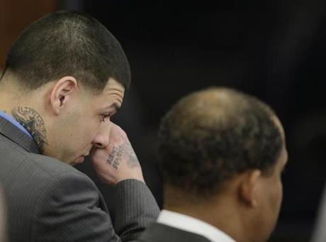 Former New England Patriots tight end Aaron Hernandez wiped tears from his eyes after his double murder acquittal at Suffolk Superior Court Friday.

