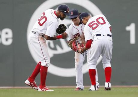 Boston, Massachusetts -- 4/16/2017 - (L-R) Red Sox players Chris Young, Andrew Benintendi and Mookie Betts celebrate their win over Tampa Bay at the end of the ninth inning of play at Fenway Park. (Jessica Rinaldi/Globe Staff) Topic: Red Sox-Rays Reporter: 
