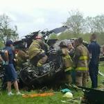 This handout photograph obtained courtesy of TheBayNet.com shows firemen investigting the wreckage of a US military UH-60 Blackhawk helicopter on April 17, 2017 at the Breton Bay Golf Course in Leonardtown, Maryland, outside Washington, DC. A crewmember was killed and two others injured when the US Army helicopter crashed at the golf course while conducting a routine training flight. Three crew members were on board. Of the two injured crew members, one was in serious condition and one in critical condition, the Army said in a statement. The Blackhawk was from the 12th Aviation Battalion, stationed at Davison Airfield, Fort Belvoir, Virginia. / AFP PHOTO / AFP PHOTO AND TheBayNet.com / TheBayNet.com / XGTY == RESTRICTED TO EDITORIAL USE / MANDATORY CREDIT: 