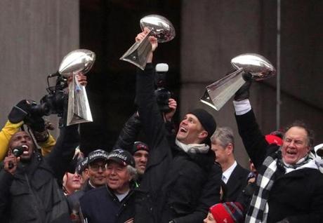New England Patriots quarterback Tom Brady, head coach Bill Belichick, and free safety Devin McCourty hoisted Lombardi trophies.
