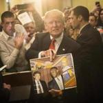 FILE - In this Jan. 29, 2016, file photo, Republican presidential candidate Donald Trump holds depictions of himself on, 