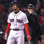Boston, MA May 1, 2017: The Red Sox Mookie Betts grimaces after he was hit by a pitch from Orioles starter Dylan Bundy. Home plate umpire Greg Gibson directs him to firstbase. The Boston Red Sox hosted the Baltimore Orioles in a regular season MLB base ball game at Fenway Park. (Globe Staff Photo/Jim Davis)