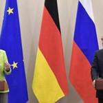 German Chancellor Angela Merkel and Russian President Vladimir Putin held a joint news conference following their meeting in Sochi, Russia, Tuesday.