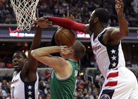 Washington, D.C. - 5/04/2017 - (1st quarter) TBoston Celtics forward Jonas Jerebko (8) is fouled from behind by Washington Wizards guard John Wall (2) on this drive during the first quarter. he Washington Wizards host the Boston Celtics in Game 3 of the Eastern Conference Semi-Finals at the Verizon Center in Washington, D.C. - (Barry Chin/Globe Staff), Section: Sports, Reporter: Adam Himmelsbach, Topic: 05Celtics-Wizards, LOID: 8.3.2398463528.
