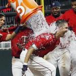 Minnesota Twins' Joe Mauer gets doused with water after his walk-off solo home run in the ninth inning off Boston Red Sox relief pitcher Matt Barnes in a baseball game Friday, May 5, 2017, in Minneapolis. The Twins won 4-3. (AP Photo/Jim Mone)
