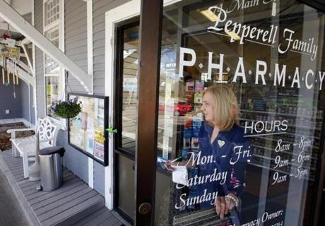 Judy Shattuck carried a prescription to the parking lot for a customer at the Pepperell Family Pharmacy in Pepperell last month. 
