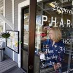 Judy Shattuck carried a prescription to the parking lot for a customer at the Pepperell Family Pharmacy in Pepperell last month. 