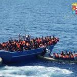 Migrants sat on a overcrowded boat during a rescue operation off the coast of Sicily as part of the 