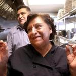 Angela Atenco Lopez with her son Luis in the kitchen at Angela's Cafe in East Boston.