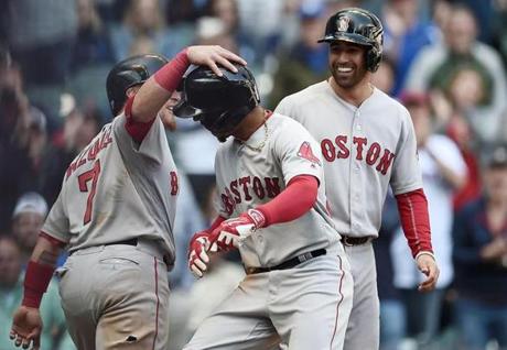 MILWAUKEE, WI - MAY 11: Mookie Betts #50 of the Boston Red Sox is congratulated by Christian Vazquez #7 following a ninth inning home run against the Milwaukee Brewers at Miller Park on May 11, 2017 in Milwaukee, Wisconsin. (Photo by Stacy Revere/Getty Images)
