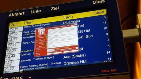 A window announcing the encryption of data and requiring a payment for access is displayed in a railway station in eastern Germany Friday. 
