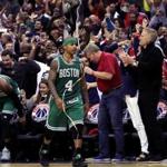 Washington, D.C. - 5/12/2017 - (4th quarter) Boston Celtics guard Isaiah Thomas (4) and Boston Celtics center Al Horford (42) head off the court towards the locker room as the confetti begins to fall celebrating the Wizard's 92-91 win in Game 6. The Washington Wizards host the Boston Celtics in Game 6 of the Eastern Conference Semi-Finals at the Verizon Center in Washington, D.C. - (Barry Chin/Globe Staff), Section: Sports, Reporter: Adam Himmelsbach, Topic: 13Celtics-Wizards, LOID: 8.3.2455943579.
