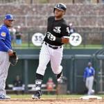 FILE - In this March 15, 2017, file photo, Chicago White Sox's Yoan Moncada rounds the bases past Kansas City Royals third baseman Ramon Torres on a two-run home run in the fifth inning of a spring training baseball game, in Glendale, Ariz. The rebuilding White Sox plan to go slow with Moncada, who just turned 21 in September. But he could bring his powerful swing and athleticism to Chicago?s starting lineup at some point this summer. (John Sleezer/The Kansas City Star via AP, File)