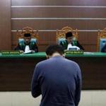 A man on trial for being in a same-sex relationship reacts as he listens to the judge at the Sharia court in Banda Aceh.