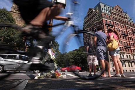 In 2015, bouquets of flowers adorned a light post at the intersection of Massachusetts Avenue and Beacon Street, where a bicyclist was struck and killed.
