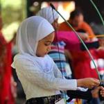 Tawhida Khaifan, 6, loaded an arrow onto her bow during an archery lesson Saturday as part of Islamic Day activities at New England Base Camp, a center for Boy Scouts and Girl Scouts in Milton.