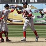 From left to right, Boston Red Sox left fielder Andrew Benintendi celebrates with second baseman Dustin Pedroia, right fielder Mookie Betts and center fielder Jackie Bradley Jr. after a baseball game against the Oakland Athletics in Oakland, Calif., Sunday, May 21, 2017. (AP Photo/Jeff Chiu)
