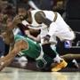 Cleveland, OH May 21, 2017: The Cavaliers Kyrie Irving leaps over the Celtics Avery Bradley in pursuit of a first quarter loose ball. The Boston Celtics visited the Cleveland Cavaliers for Game Three of their NBA Eastern Conference Finals playoff series at the Quicken Loans Arena. (Globe Staff Photo/Jim Davis)