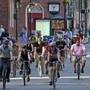 BOSTON, MA - 5/19/2017:Bikers in mass rdie down Washington Street Boston. National Bike to Work Day on Friday, May 19, 2017. In total, 13 bike convoys will made stops at locations across the metro Boston area, and cyclists will meet at Boston City Hall Plaza in the morning for a festival that will include music, exhibits and breakfast. Other cyclists gathered at City Hall Plaza, wearing black in protest and for a silent vigil. (David L Ryan/Globe Staff Photo) SECTION: METRO TOPIC 20jaywalkers