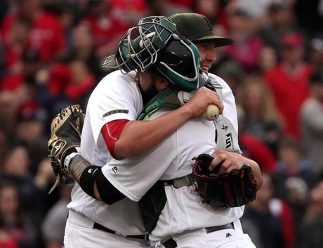 Boston, MA - 5/27/2017 - (9th inning) Boston Red Sox starting pitcher Brian Johnson (61) shares an embrace with Boston Red Sox catcher Sandy Leon (3) following his complete game shutout over the Seattle Mariners. The Boston Red Sox host the Seattle Mariners in the second of a three game series at Fenway Park. - (Barry Chin/Globe Staff), Section: Sports, Reporter: Peter Abraham, Topic: 28Sox-Mariners, LOID: 8.3.2575145591.
