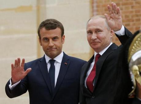 French President Emmanuel Macron and Russian President Vladimir Putin greeted journalists at the Palace of Versailles on May 29, 2017.e first Western leader to speak to Putin after the talks. (AP Photo/Alexander Zemlianichenko, pool)
