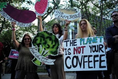 Environmental activists and supporters display placards during a demonstration in New York on June 1, 2017, to protest US President Donald Trump's decision to pull out of the 195-nation Paris climate accord deal. US President Donald Trump earlier announced America is 