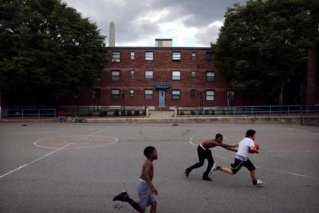 Boys played football at the Bunker Hill Housing Development in 2015.
