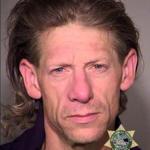 A police booking photo  shows George Tschaggeny, suspected of stealing the wedding ring and backpack of one of two men fatally stabbed on a commuter train on May 26 in Portland, Ore.