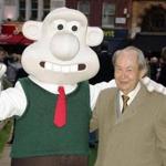 FILE - In this Sunday, Oct. 2, 2005 file photo, British actor Peter Sallis, who voices the part of Wallace poses with a person dressed as the character 'Wallace' on arrival at the Leicester Square Odeon, London for the premiere of Wallace & Grommit: The Curse of the Were-Rabbit. Sallis, who played irrepressible, cheese-loving inventor Wallace in the 