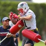 Foxborough-06/08/2017- Patriots minicamp at the Gillette Stadium practice field. Julian Edelman catches a pass as he is hit with blockers during a drill. John Tlumacki/The Boston Globe