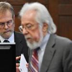 The state's Chief Medical Examiner Dr. Henry Nields reviewed his autopsy report under cross examination by defense attorney Jonathan Shapiro, right, during the trial of Michael McCarthy on Thursday.