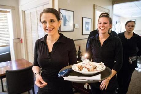 Servers Kate Titberidze (left) and Samantha Klesaris broiught out dessert at Good Thymes in Lowell.
