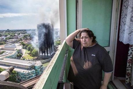A local resident stood distraught as smoke engulfed the nearby tower. 
