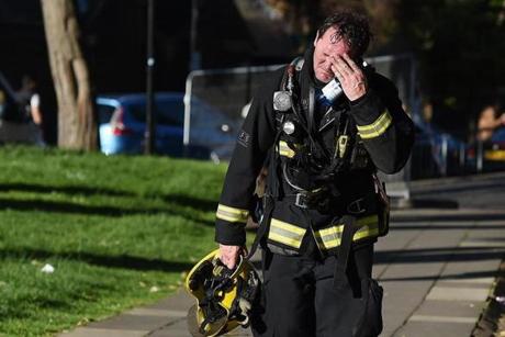 A fireman wiped his brow after battling the tower fire.
