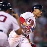 Boston, MA: June 12, 2017: Red Sox 1B coach Ruben Amaro, Jr. (left) gives Mookie Betts the signal to go for two, as he rounds first on a fourth inning double, the third of three straight two baggers he had in the game. The Boston Red Sox hosted the Philadelphia Phillies in a regular season MLB inter league baseball game at Fenway Park. Globe Staff Photo/ Jim Davis) 
