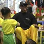 Former NBA basketball star Dennis Rodman sits with children from the Pyongyang orphanage and nursery that he visited on Thursday, June 15, 2017, in Pyongyang, North Korea. (AP Photo/Kim Kwang Hyon)