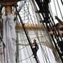 Cadets climb the rigging Saturday while dousing the sails aboard the USCGC Eagle during the Grand Parade of Sail in Boston.