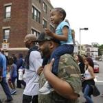 Boston, MA -- 6/18/2017 - Akeem Jackson (C) carries his daughter Aubrey, 3, on his shoulders during the Father's Day Unity Walk. (Jessica Rinaldi/Globe Staff) Topic: 19fathers Reporter: 