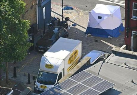 Forensic experts stood next to the van suspected of running down people on Monday in Finsbury Park, London.
