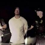 In this image taken from video golfer Tiger Woods stands between two police officers in Jupiter Florida Monday May 29,2017. Police in the US state of Florida have released video of professional golfer Tiger Woods' recent arrest. Jupiter Police released the dash-cam footage of the incident late on Wednesday May 31, 2017. Officers on patrol early on Monday noticed a Mercedes pulled awkwardly to the side of the road with the engine running, the brake lights on and a right indicator blinking. (Jupiter Police Department/via AP)