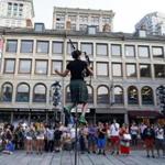 Street performer Sara Kunz juggled hula hoops from atop a pole for passersby in Downtown Crossing in Boston.
