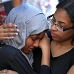 Akhi Begum (left), 20, of Cambridge was comforted by Johaisi Reyes, 21, during the vigil.