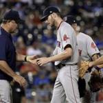 Boston Red Sox starting pitcher Chris Sale hands the ball to manager John Farrell as he leaves during the ninth inning of the team's baseball game against the Kansas City Royals Tuesday, June 20, 2017, in Kansas City, Mo. The Red Sox won 8-3. (AP Photo/Charlie Riedel)