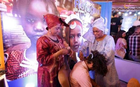 Somali refugees braided hair at a World Refugee Day event in Damascus, Syria this week. Massachussetts lawmakers are working to reduce barriers in the state to hair braiders, who are mostly African-American women and women of African and Caribbean descent.
