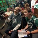Boston Celtics fans William Goodman, left, and his son Eli, of Hollis, N.H., watch during the team's NBA basketball draft party at TD Garden, Thursday, June 22, 2017, in Boston. The Celtics chose Jayson Tatum in the first round. (AP Photo/Elise Amendola)