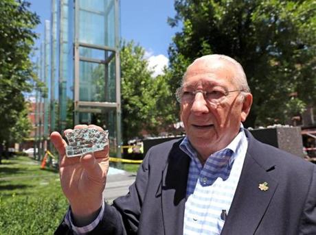 BOSTON, MA - 6/28/2017: Holding a piece of the broken glass is Israel Arbeiter, president of The American Association of Jewish Holocaust Survivors of Greater Boston. A plate of glass at the New England Holocaust Memorial in downtown Boston was damaged early Wednesday, destroying at least one of the 54 panes of glass etched with the numbers tatooed onto the amrs of Jews murdered in Nazi death camps. ADL and other groups held a press conf in front of memorial to blast vandalism (David L Ryan/Globe Staff ) SECTION: METRO TOPIC 29memorial

