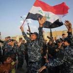 Members of the Iraqi federal police danced with children and a national flag during a celebration of the end of military operations against Islamic State fighters in the Old City of Mosul on Sunday.