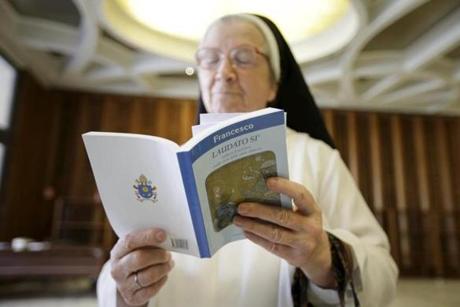 A nun read Pope Francis' new encyclical titled ?Laudato si? at the Vatican in 2015. 
