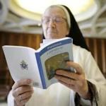 A nun read Pope Francis' new encyclical titled ?Laudato si? at the Vatican in 2015. 