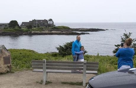Visitors to Kennebunkport used the summer estate of George H.W. Bush, the 41st president, and his wife, Barbara Bush, as the background for their photos. Tourists often stream down Ocean Drive to gaze at the Walker?s Point residence.
